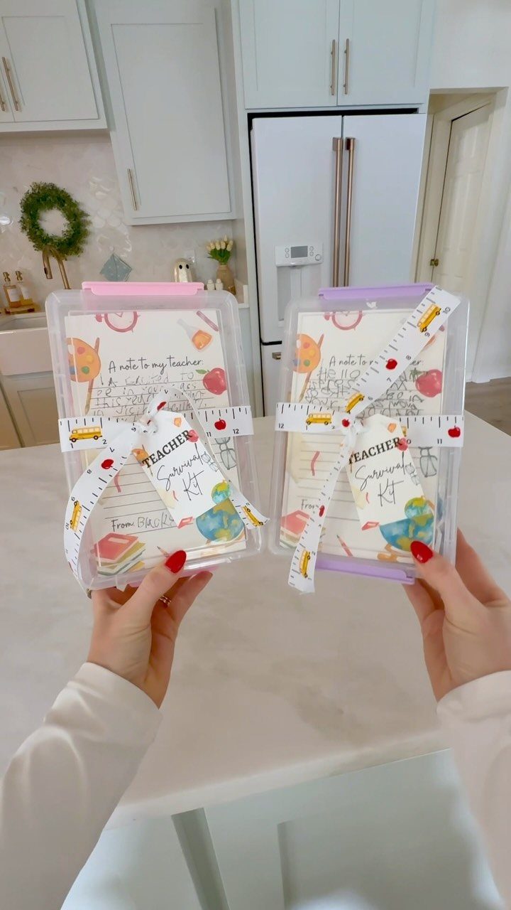 Two teacher survival kits in clear plastic boxes with decorative tags and ribbons.