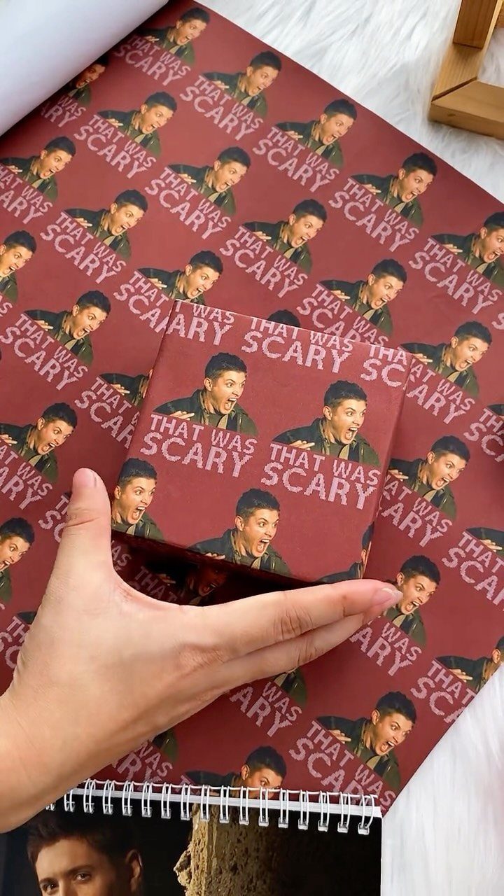 Small gift wrapped in custom photo paper featuring a man's face and text.