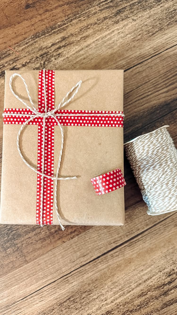 Brown kraft paper gift wrapped with red polka dot washi tape and white twine.